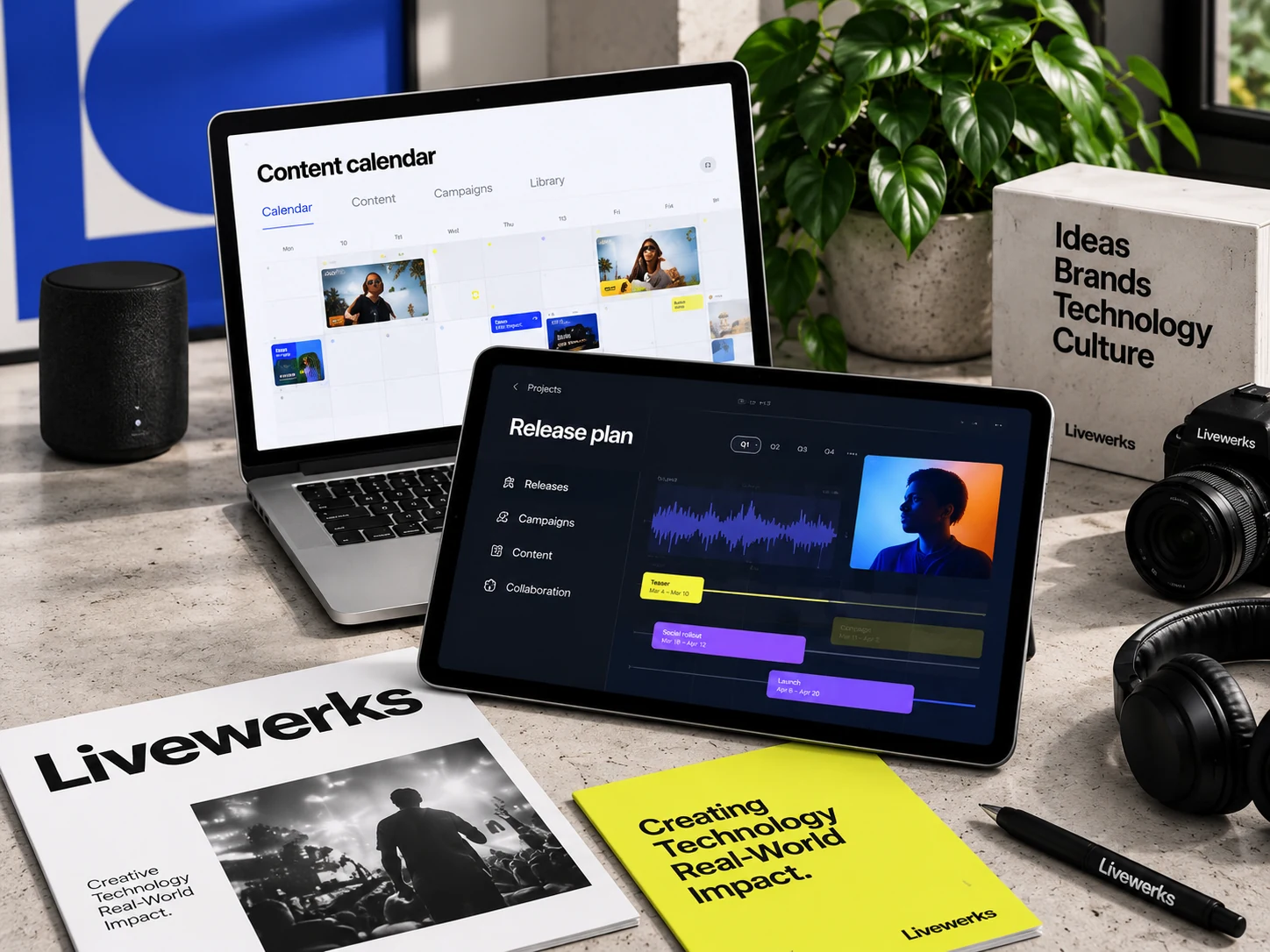 Creative workspace with a content calendar laptop, music release tablet, camera, and Livewerks publications.